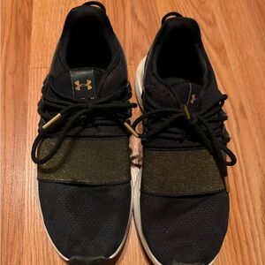 Black and Gold Under Armour tennis shoes